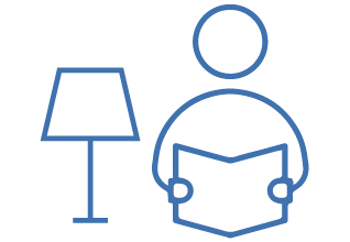 Icon of a person reading under a desk lamp